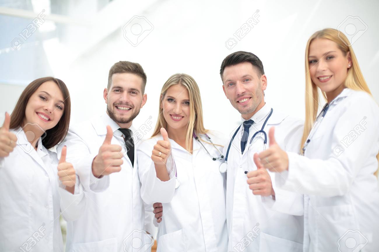 Portrait of happy doctors team showing thumbs up